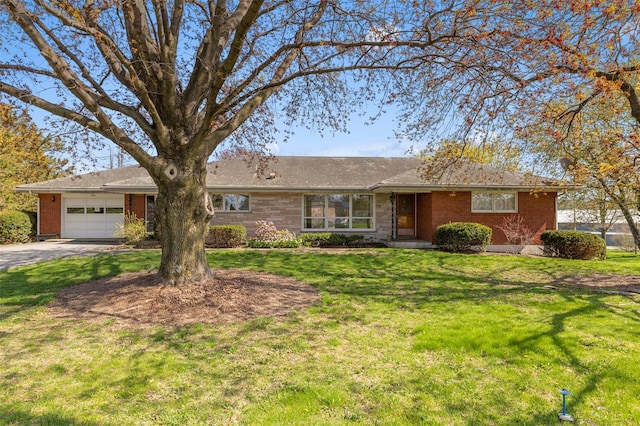 single story home featuring brick siding, an attached garage, driveway, and a front lawn