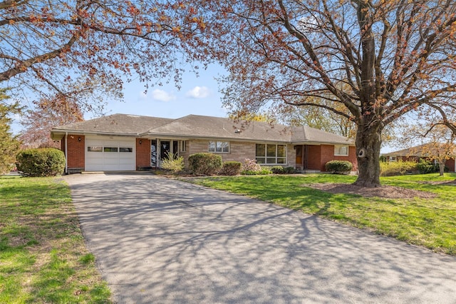 ranch-style house featuring brick siding, a garage, aphalt driveway, and a front yard