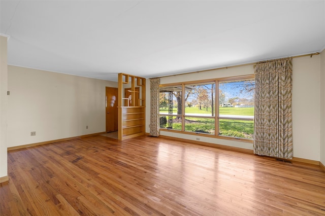 unfurnished living room featuring baseboards, visible vents, and light wood-type flooring