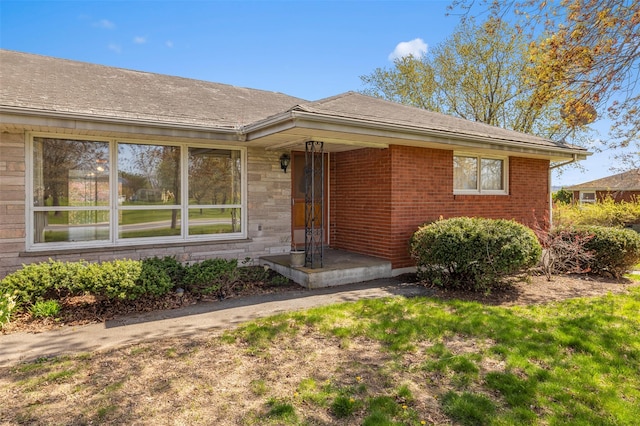 entrance to property featuring brick siding