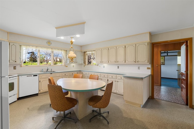kitchen with a kitchen island, a sink, light countertops, a breakfast bar, and white appliances