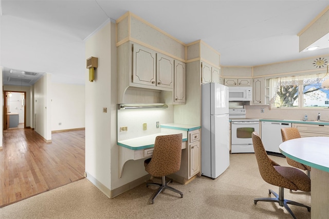 kitchen with a sink, white appliances, light countertops, baseboards, and ornamental molding