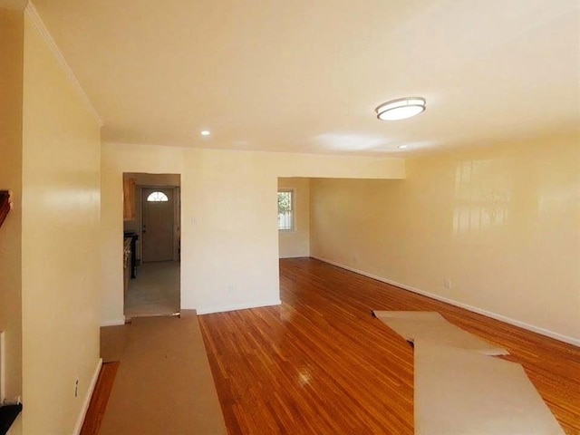 empty room featuring recessed lighting, wood finished floors, and baseboards