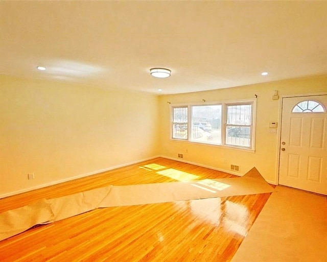 foyer featuring recessed lighting, visible vents, wood finished floors, and baseboards