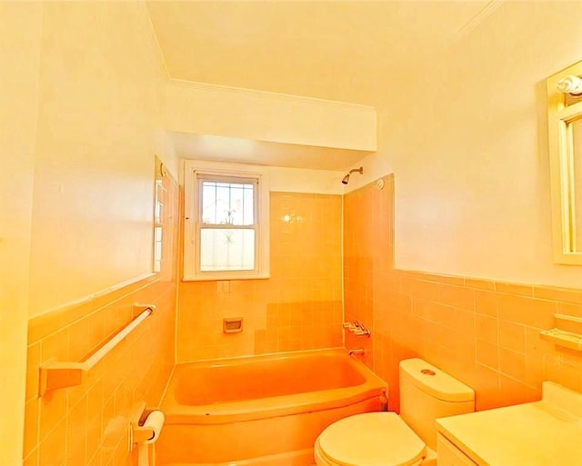 full bath featuring tile walls, toilet, shower / bath combination, and crown molding