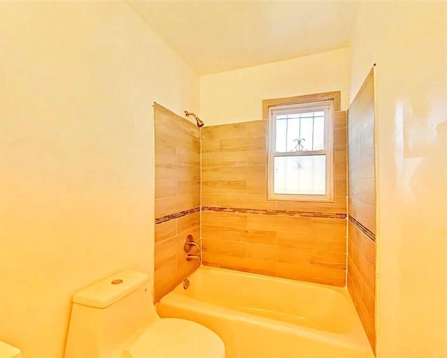 bathroom with shower / bathing tub combination and toilet