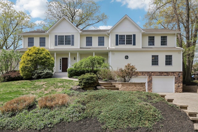 27 Lindbergh Ln, New City, NY 10956 - traditional-style home with covered porch, driveway, stone siding, and a garage