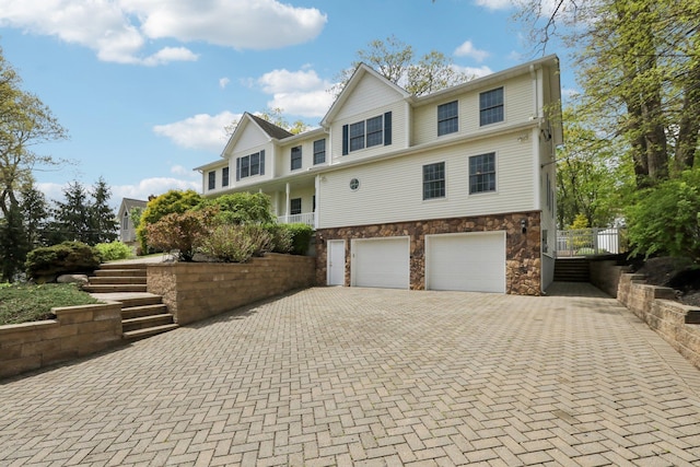 27 Lindbergh Ln, New City, NY 10956 - view of front of property with decorative driveway, stairs, stone siding, and a garage