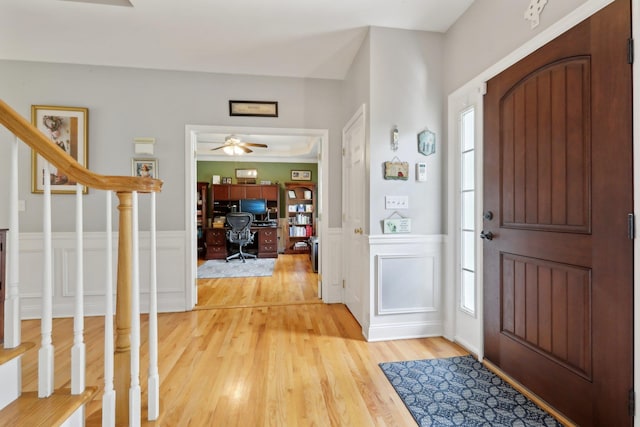 27 Lindbergh Ln, New City, NY 10956 - entrance foyer with light wood finished floors, a decorative wall, a wainscoted wall, a wealth of natural light, and stairway
