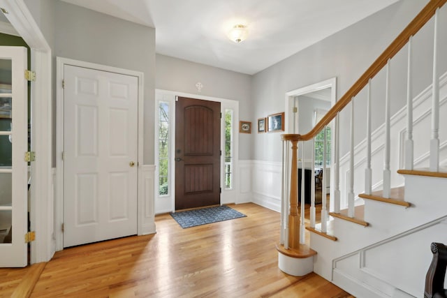 27 Lindbergh Ln, New City, NY 10956 - entrance foyer featuring light wood-style floors, a wainscoted wall, a decorative wall, and stairs