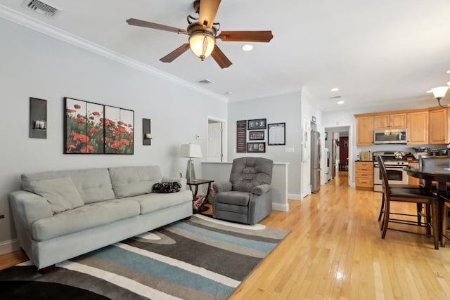 27 Lindbergh Ln, New City, NY 10956 - living room featuring visible vents, ceiling fan with notable chandelier, light wood finished floors, ornamental molding, and recessed lighting
