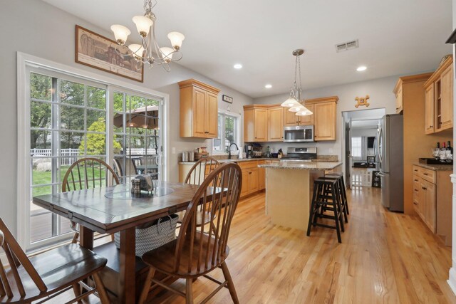 27 Lindbergh Ln, New City, NY 10956 - dining room with visible vents, light wood-style floors, plenty of natural light, and a notable chandelier