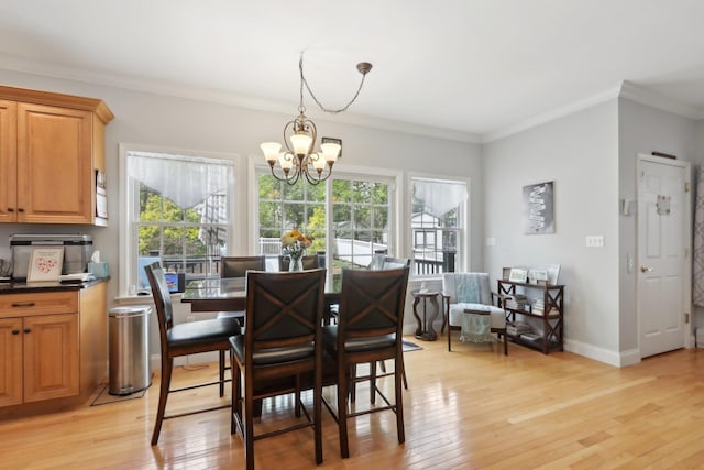 27 Lindbergh Ln, New City, NY 10956 - dining room featuring light wood-style floors, plenty of natural light, ornamental molding, and a notable chandelier