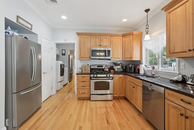 27 Lindbergh Ln, New City, NY 10956 - kitchen featuring washing machine and dryer, a sink, light wood finished floors, ornamental molding, and stainless steel appliances