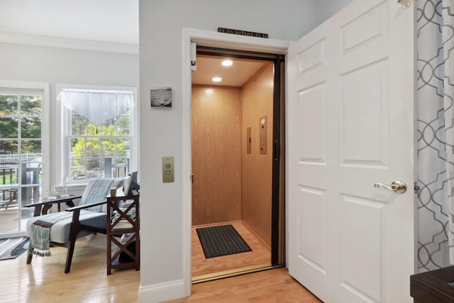 27 Lindbergh Ln, New City, NY 10956 - entryway with crown molding, elevator, baseboards, and light wood-style floors