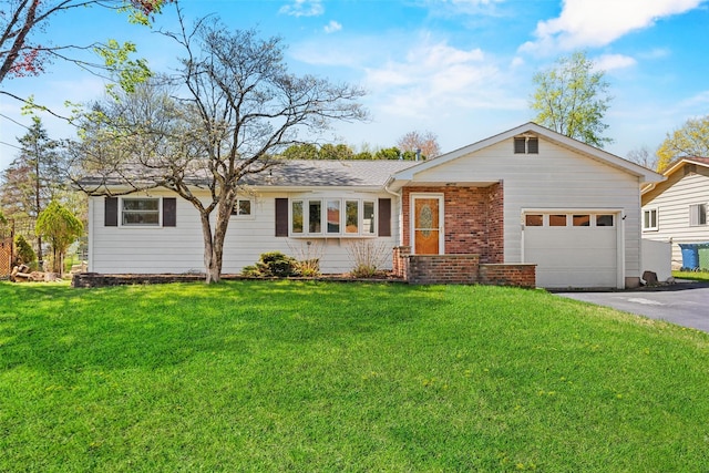 ranch-style house featuring brick siding, an attached garage, a front lawn, and aphalt driveway