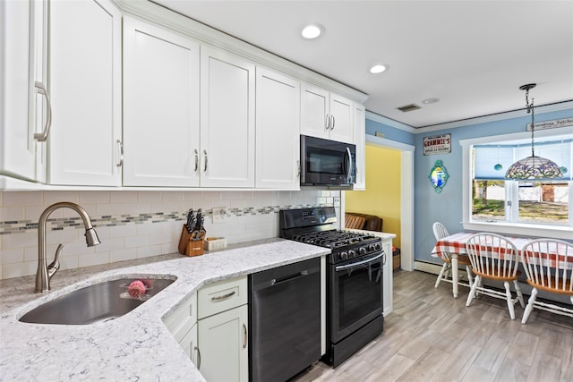 kitchen featuring tasteful backsplash, dishwasher, a sink, white cabinets, and black range with gas stovetop