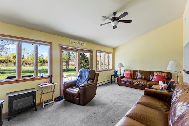 living area with carpet flooring, ceiling fan, baseboards, vaulted ceiling, and a baseboard heating unit