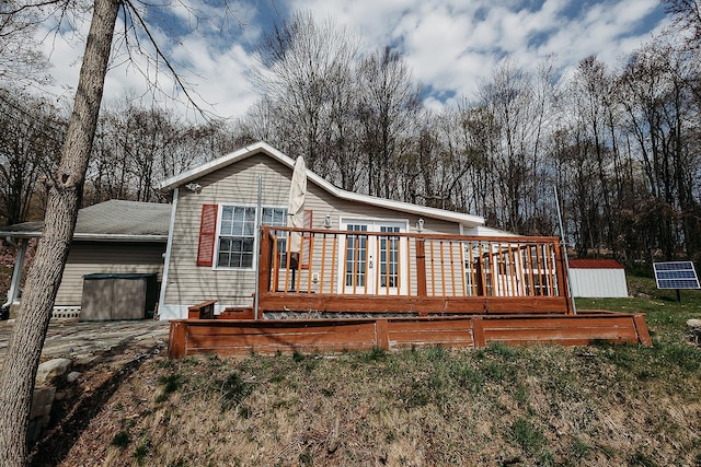 back of property with a deck and french doors