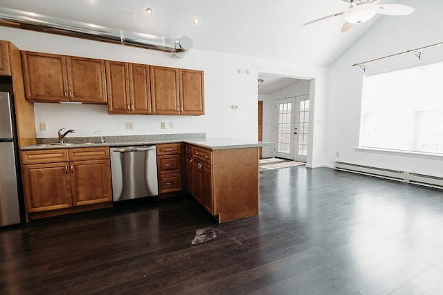 kitchen featuring appliances with stainless steel finishes, brown cabinets, a ceiling fan, and vaulted ceiling
