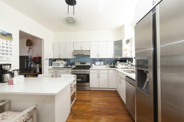 1727 E 14th St, Brooklyn, NY 11229 - kitchen featuring stainless steel appliances, under cabinet range hood, light countertops, open shelves, and decorative backsplash