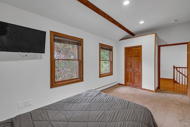 carpeted bedroom with a baseboard radiator, recessed lighting, and baseboards