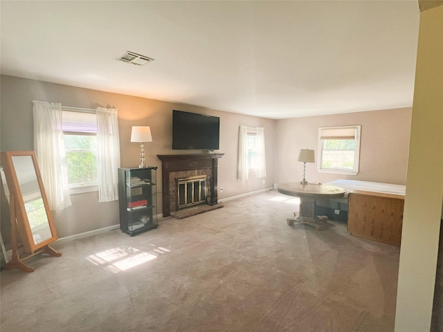 19 Millbrook Dr, Stony Brook, NY 11790 - living room with a glass covered fireplace, carpet floors, baseboards, and visible vents