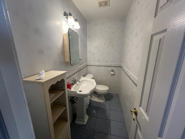 19 Millbrook Dr, Stony Brook, NY 11790 - half bathroom featuring a sink, tile patterned flooring, toilet, and visible vents