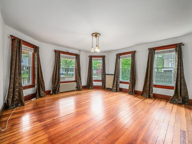 31 Highland Ave, Otisville, NY 10963 - empty room with radiator, healthy amount of natural light, wood-type flooring, and baseboards