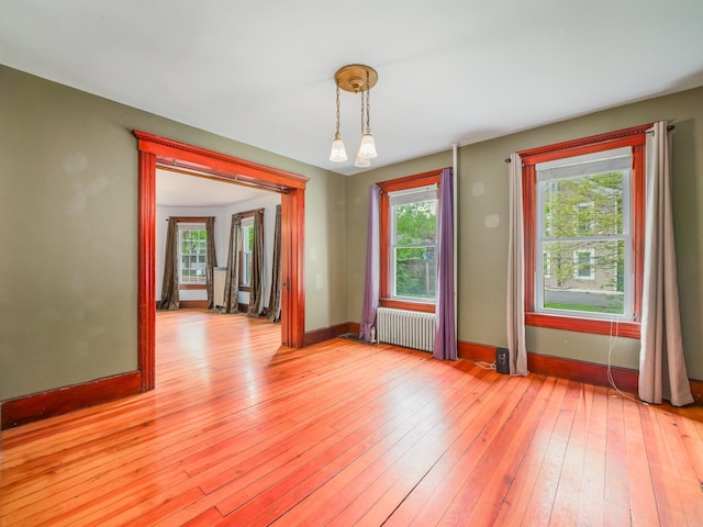 31 Highland Ave, Otisville, NY 10963 - unfurnished dining area with radiator, plenty of natural light, light wood-style floors, and baseboards
