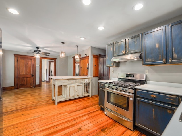 31 Highland Ave, Otisville, NY 10963 - kitchen featuring stainless steel range with gas cooktop, under cabinet range hood, light countertops, a ceiling fan, and light wood-type flooring