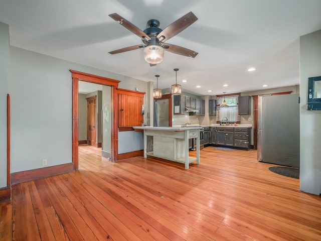 31 Highland Ave, Otisville, NY 10963 - kitchen featuring stainless steel appliances, a sink, baseboards, light wood-style floors, and light countertops