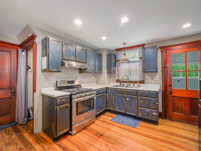 31 Highland Ave, Otisville, NY 10963 - kitchen with gas stove, a sink, under cabinet range hood, light countertops, and recessed lighting