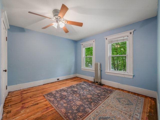 31 Highland Ave, Otisville, NY 10963 - empty room featuring radiator heating unit, wood finished floors, baseboards, and a ceiling fan