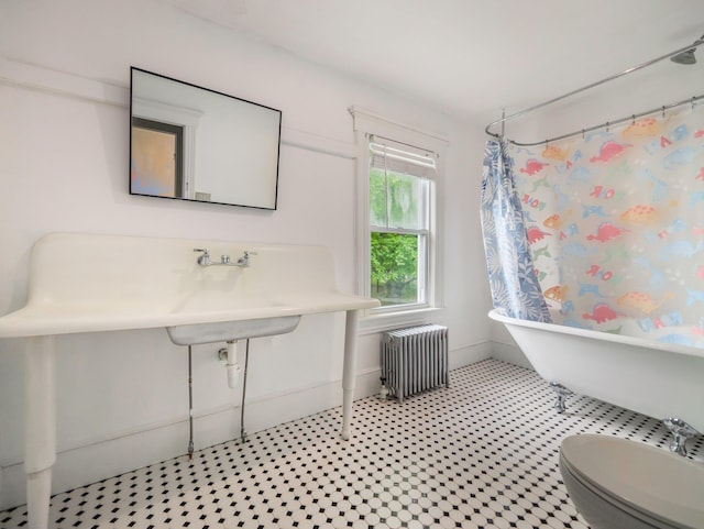 31 Highland Ave, Otisville, NY 10963 - full bath featuring radiator heating unit, a soaking tub, curtained shower, toilet, and baseboards