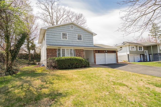 traditional-style home with a front lawn, a gambrel roof, brick siding, an attached garage, and driveway