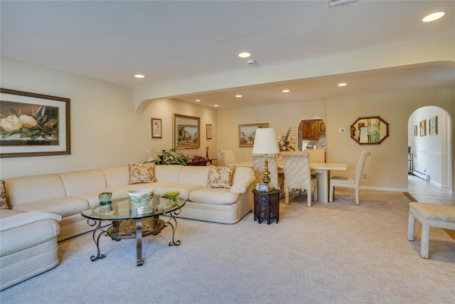 living area with carpet floors, arched walkways, and recessed lighting