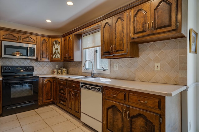kitchen featuring light countertops, stainless steel microwave, black range with electric cooktop, and dishwasher
