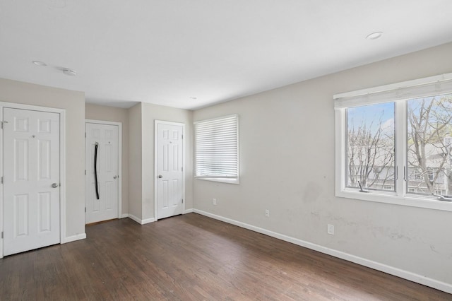 unfurnished bedroom with baseboards and wood finished floors