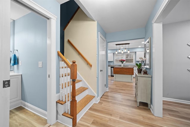 stairs featuring baseboards and wood finished floors
