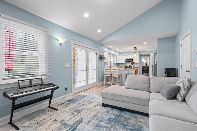 living room featuring recessed lighting, baseboards, vaulted ceiling, and french doors