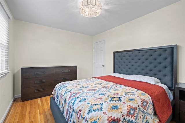 bedroom featuring light wood-style floors and baseboards