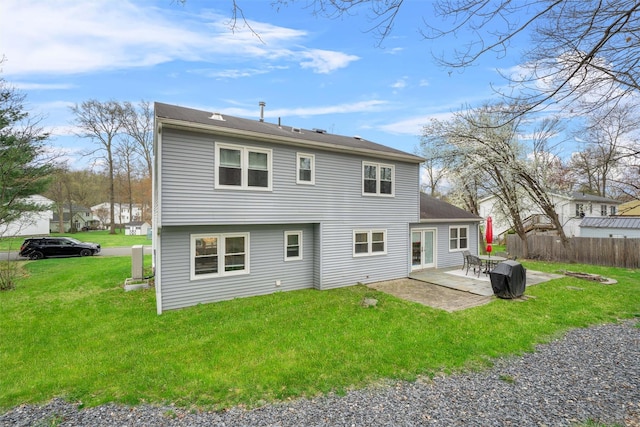 back of property featuring a patio, fence, and a yard