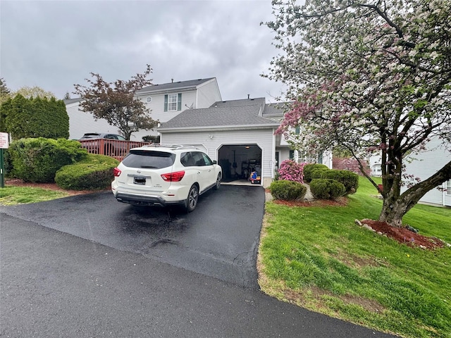 5 Fox Meadow Dr, Woodbury, NY 10930 - view of front facade featuring a front lawn, aphalt driveway, and an attached garage