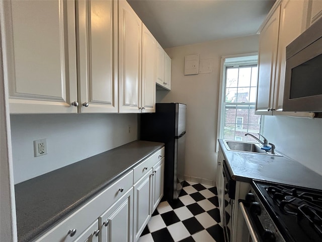 6 Midland Gdns Unit 5A, Bronxville, NY 10708 - kitchen with appliances with stainless steel finishes, a sink, light floors, white cabinets, and dark countertops