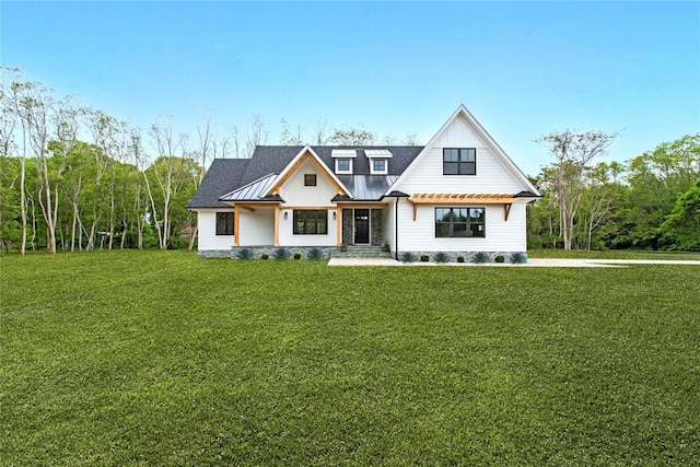 33 Lagoon Ct, Jamesport, NY 11901 - modern farmhouse style home featuring a front yard, metal roof, board and batten siding, and a standing seam roof