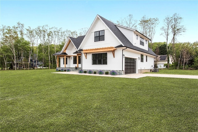 33 Lagoon Ct, Jamesport, NY 11901 - modern farmhouse featuring an attached garage, driveway, a front yard, and roof with shingles