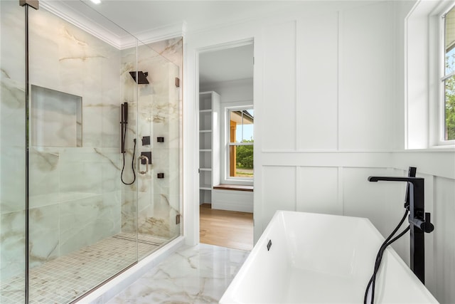 33 Lagoon Ct, Jamesport, NY 11901 - bathroom with marble tiled flooring, ornamental molding, a soaking tub, a stall shower, and a decorative wall