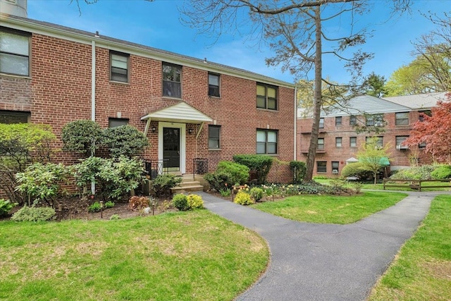 19 Rockledge Rd Unit 1A, Hartsdale, NY 10530 - view of front of house with brick siding and a front lawn
