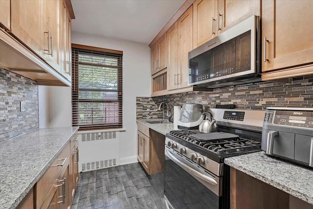 19 Rockledge Rd Unit 1A, Hartsdale, NY 10530 - kitchen with appliances with stainless steel finishes, a sink, radiator, dark wood-type flooring, and tasteful backsplash